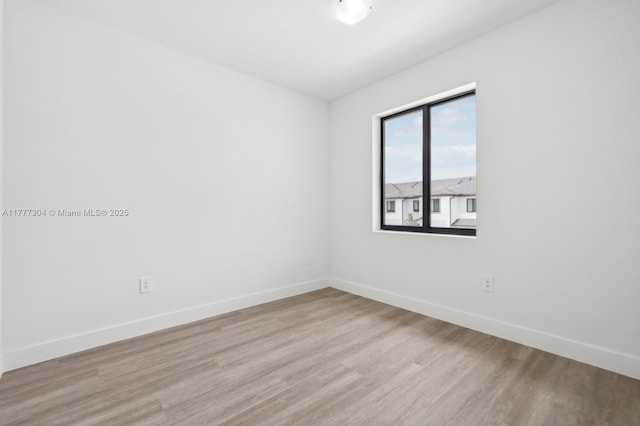18918 SW 345th Ter, Homestead, FL 33034 - spare room featuring baseboards and light wood-style flooring