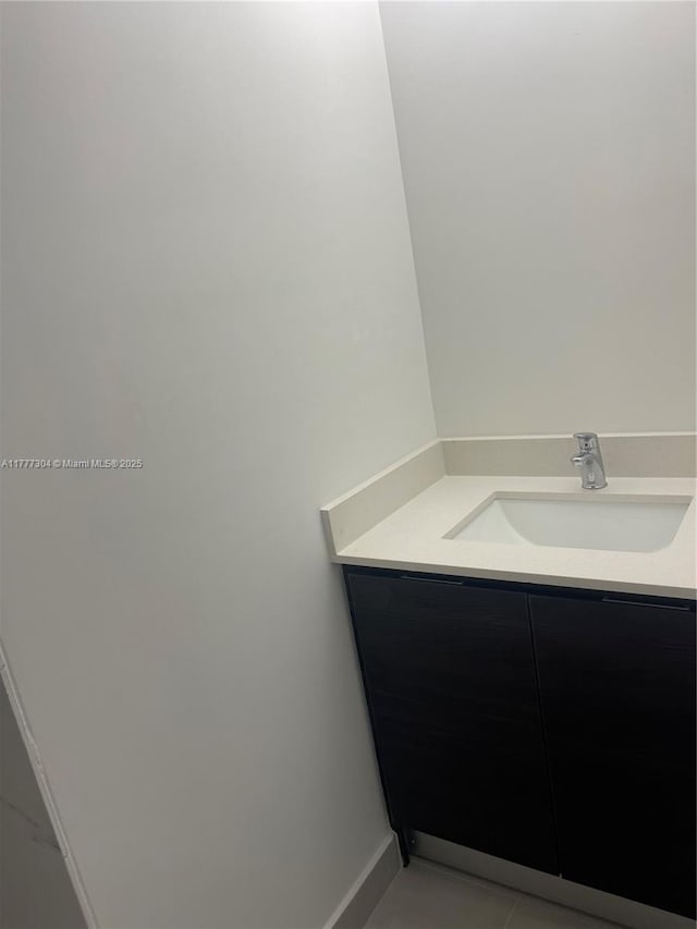bathroom with tile patterned flooring and vanity