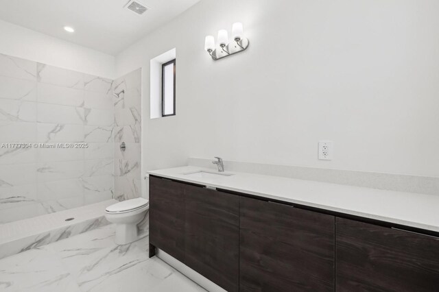 18918 SW 345th Ter, Homestead, FL 33034 - full bathroom with marble look tile flooring, a marble finish shower, toilet, and vanity