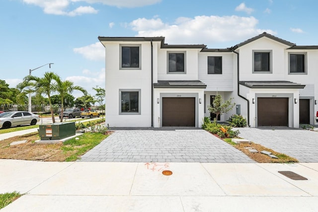 18918 SW 345th Ter, Homestead, FL 33034 - view of front facade featuring an attached garage, decorative driveway, and stucco siding
