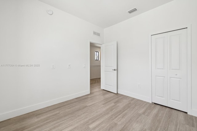 18918 SW 345th Ter, Homestead, FL 33034 - unfurnished bedroom featuring light wood-style floors, a closet, and baseboards