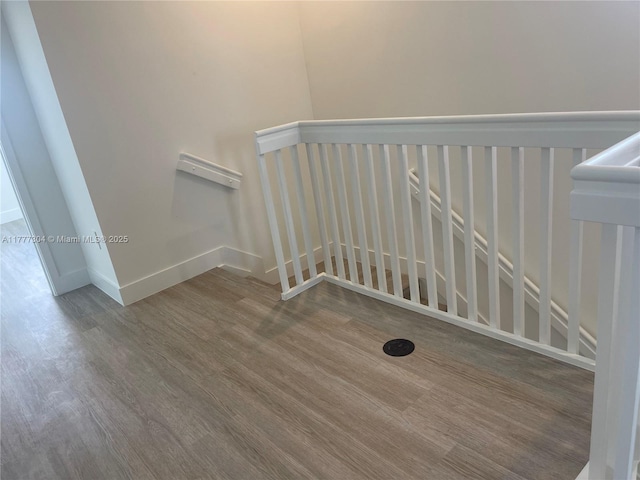 stairs with baseboards and wood finished floors