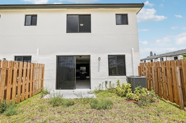 18918 SW 345th Ter, Homestead, FL 33034 - rear view of property featuring stucco siding, a fenced backyard, and central air condition unit