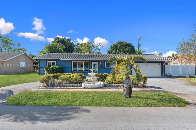 4340 NW 6th St, Plantation, FL 33317 - single story home with stucco siding, fence, an attached garage, driveway, and a front yard