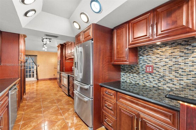 4340 NW 6th St, Plantation, FL 33317 - kitchen featuring light tile patterned flooring, visible vents, stainless steel appliances, a raised ceiling, and backsplash