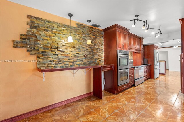 4340 NW 6th St, Plantation, FL 33317 - kitchen featuring visible vents, baseboards, appliances with stainless steel finishes, reddish brown cabinets, and decorative light fixtures