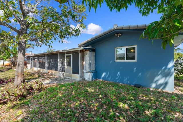 4340 NW 6th St, Plantation, FL 33317 - view of front of property with stucco siding and a sunroom