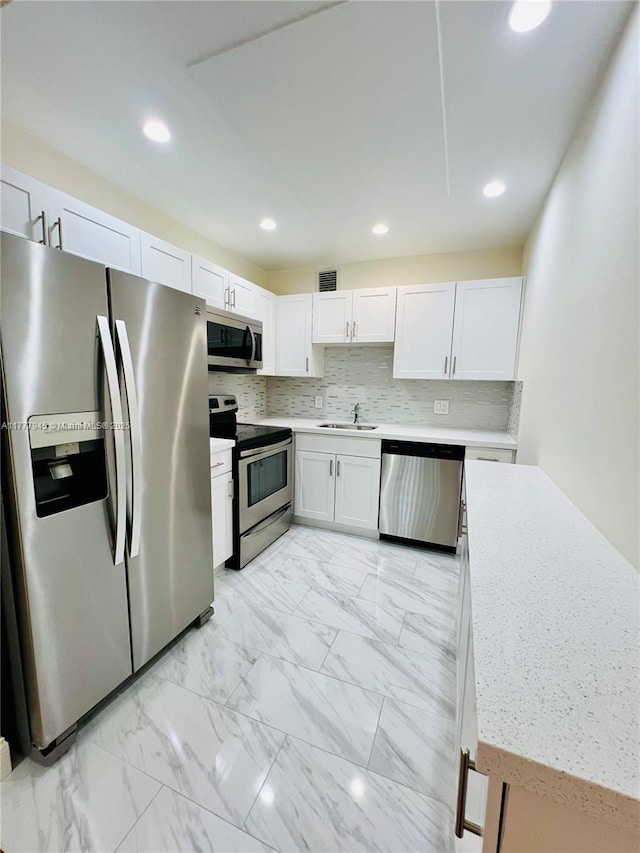 13250 SW 4th Ct Unit 405G, Pembroke Pines, FL 33027 - kitchen with stainless steel appliances, light countertops, white cabinetry, light marble finish floors, and recessed lighting