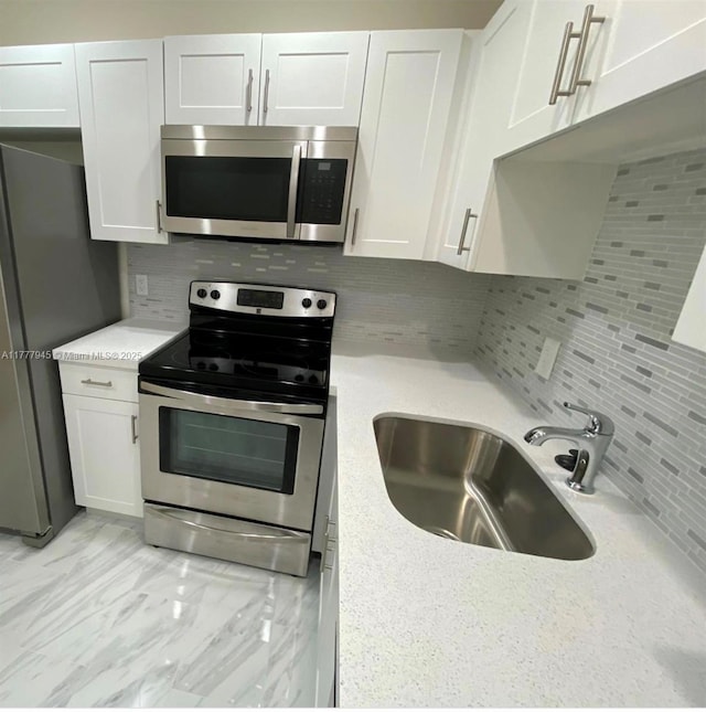 13250 SW 4th Ct Unit 405G, Pembroke Pines, FL 33027 - kitchen featuring stainless steel appliances, tasteful backsplash, and white cabinets