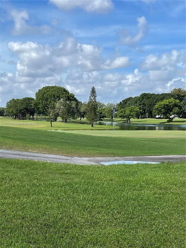 13250 SW 4th Ct Unit 405G, Pembroke Pines, FL 33027 - surrounding community with a water view, a lawn, and view of wooded area