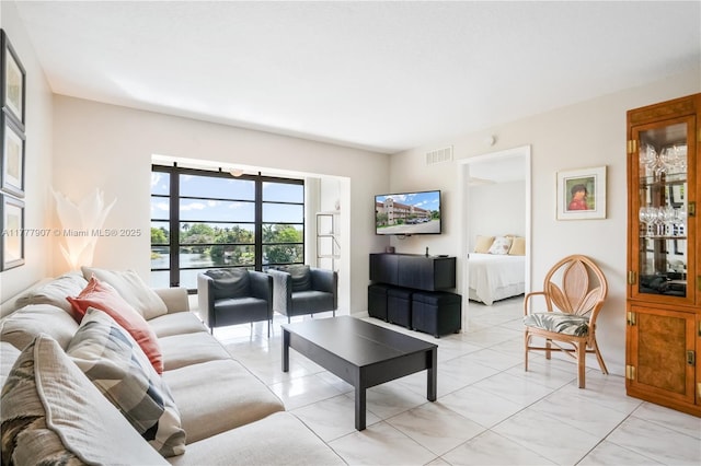 living room featuring visible vents and light tile patterned floors
