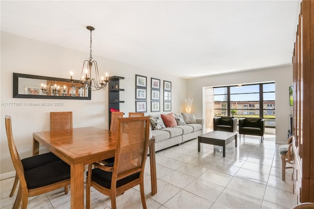 dining area featuring light tile patterned flooring and a chandelier
