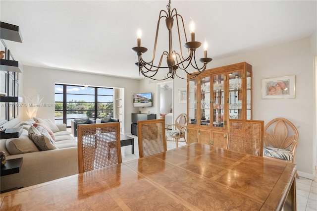 dining space with baseboards and an inviting chandelier