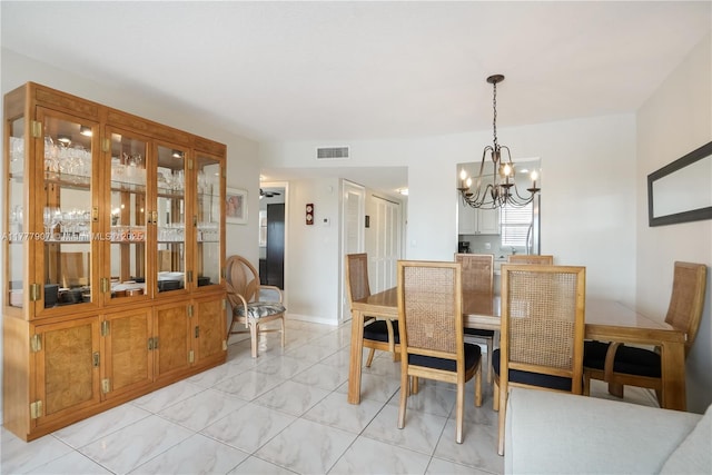 dining room featuring visible vents and a chandelier