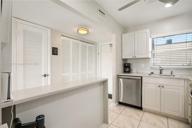 kitchen featuring stainless steel dishwasher, white cabinets, ceiling fan, and light countertops