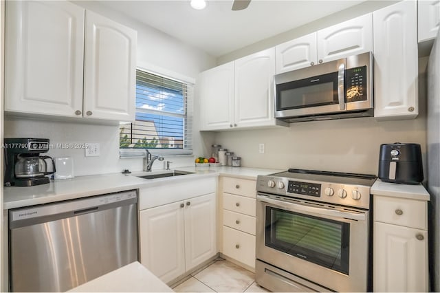 kitchen with white cabinets, a sink, light countertops, and appliances with stainless steel finishes