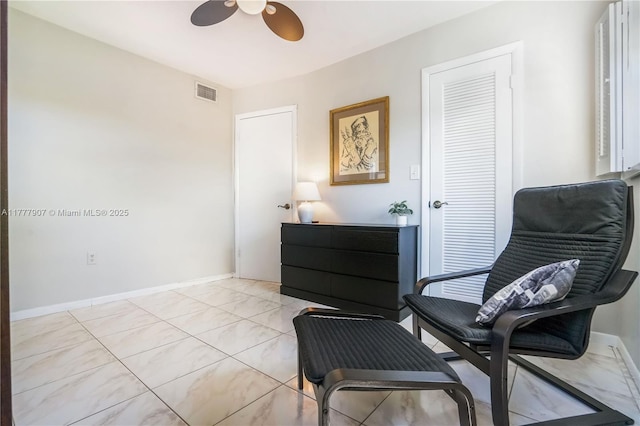 sitting room with a ceiling fan, baseboards, and visible vents