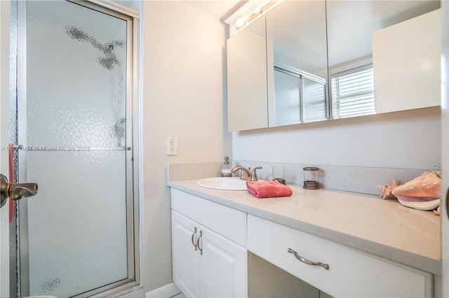 bathroom featuring a stall shower and vanity