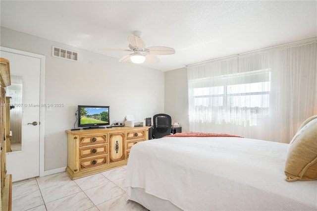 bedroom featuring visible vents, ceiling fan, and light tile patterned floors