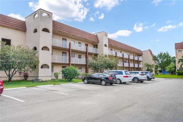 view of building exterior with uncovered parking