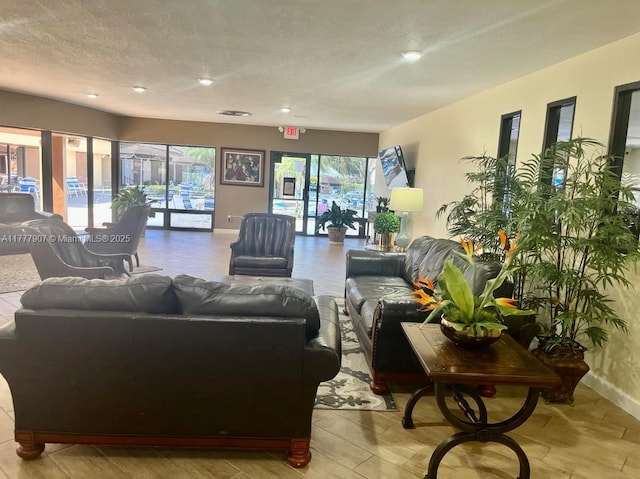 living area featuring baseboards and a textured ceiling