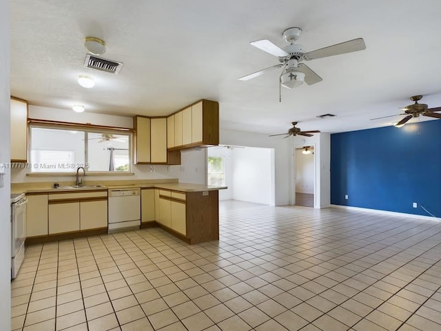 kitchen featuring range with electric stovetop, dishwasher, visible vents, a sink, and open floor plan