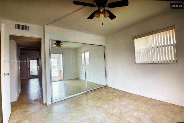 21 Saxony A 21, Delray Beach, FL 33446 - unfurnished bedroom featuring a closet, a ceiling fan, and tile patterned floors