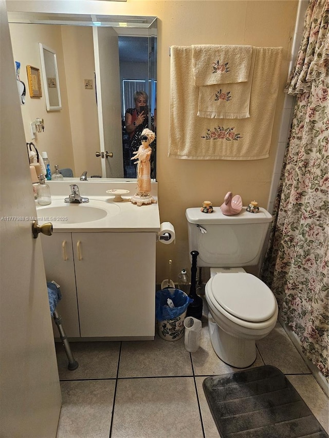 full bath featuring a shower with curtain, tile patterned flooring, vanity, and toilet