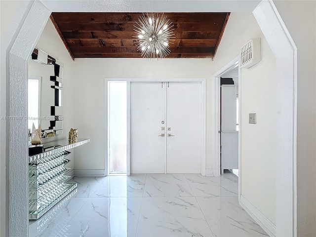 foyer with baseboards, a notable chandelier, wood ceiling, marble finish floor, and lofted ceiling