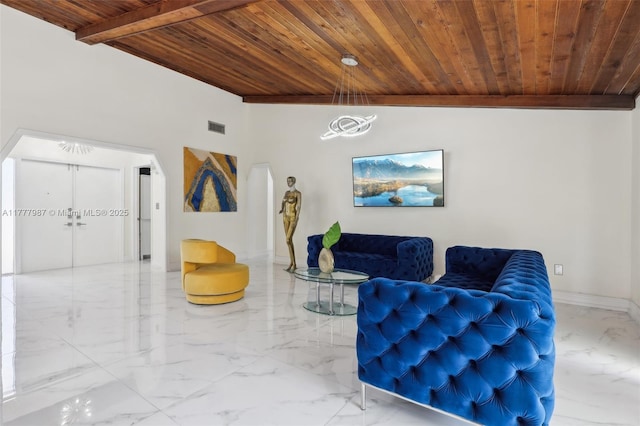 living area with wood ceiling, marble finish floor, baseboards, and visible vents