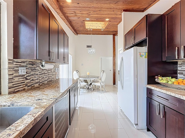 kitchen featuring tasteful backsplash, light tile patterned floors, white refrigerator with ice dispenser, decorative light fixtures, and wooden ceiling