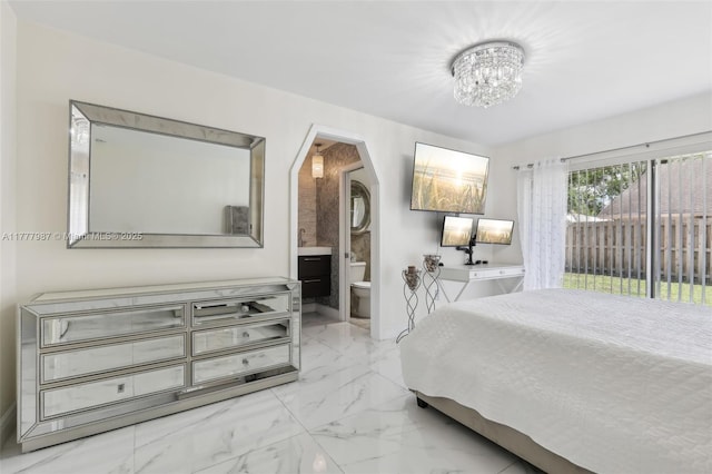 bedroom with connected bathroom, arched walkways, access to exterior, marble finish floor, and a notable chandelier
