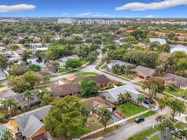 drone / aerial view featuring a residential view and a water view