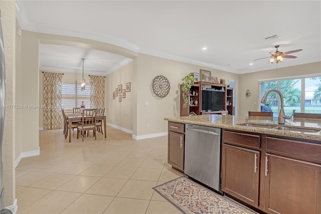 kitchen with stainless steel dishwasher, a sink, baseboards, visible vents, and crown molding