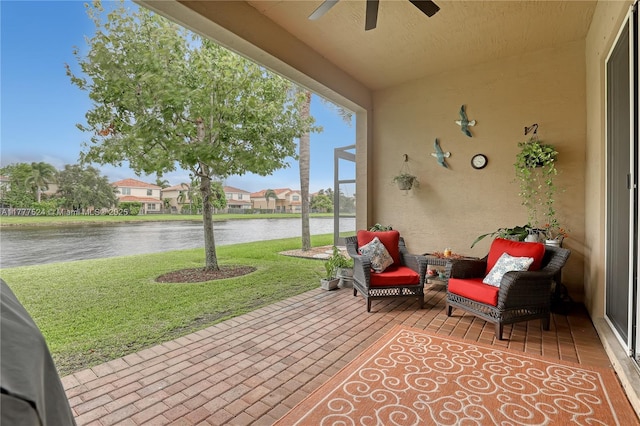 view of patio with a ceiling fan, a residential view, and a water view