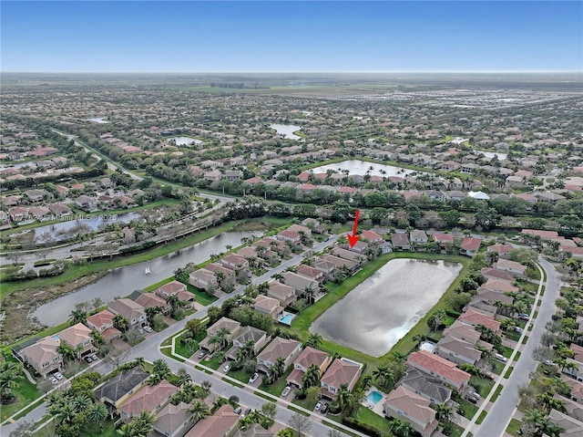 birds eye view of property featuring a residential view and a water view