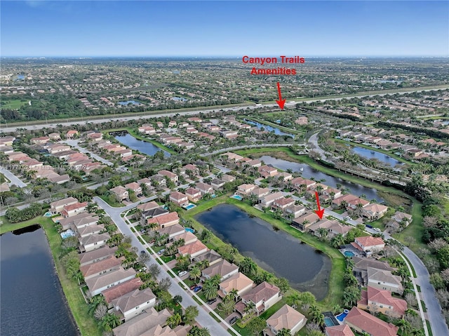bird's eye view featuring a residential view and a water view