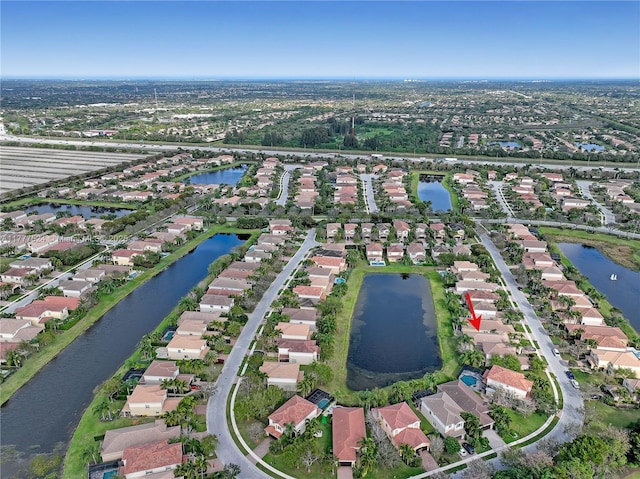 bird's eye view with a residential view and a water view