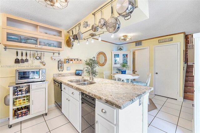 11861 SW 13th Ct, Davie, FL 33325 - kitchen featuring a sink, a peninsula, dishwasher, a textured ceiling, and light tile patterned floors