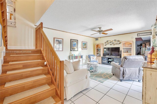 11861 SW 13th Ct, Davie, FL 33325 - living area with stairs, a ceiling fan, light tile patterned floors, a textured ceiling, and crown molding