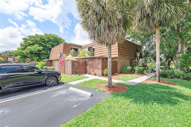 11861 SW 13th Ct, Davie, FL 33325 - townhome / multi-family property with mansard roof, uncovered parking, and brick siding