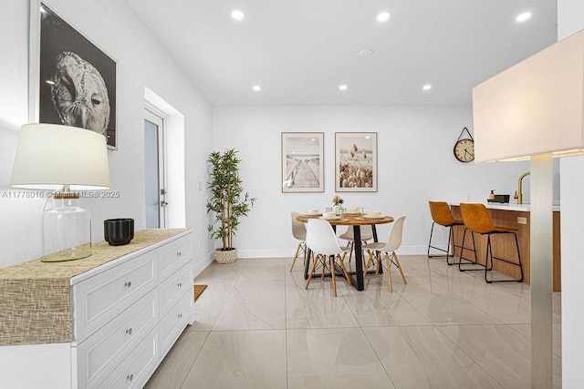 dining room featuring baseboards and recessed lighting