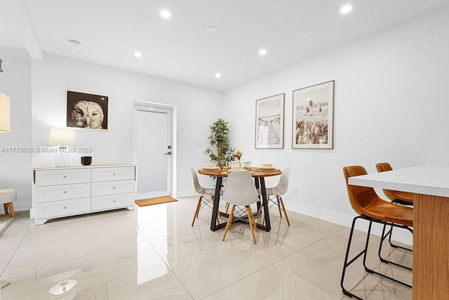 dining area with light tile patterned floors, baseboards, and recessed lighting