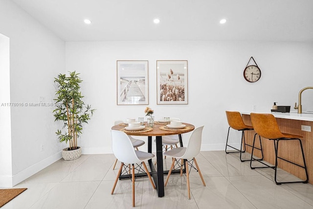 dining room featuring light tile patterned floors, baseboards, and recessed lighting