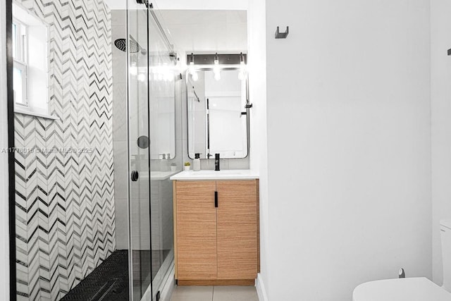 bathroom featuring toilet, vanity, tile patterned flooring, and a shower stall