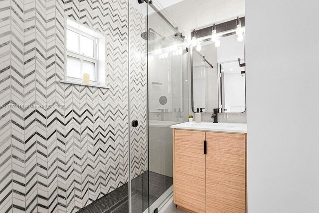 bathroom with vanity and a stall shower