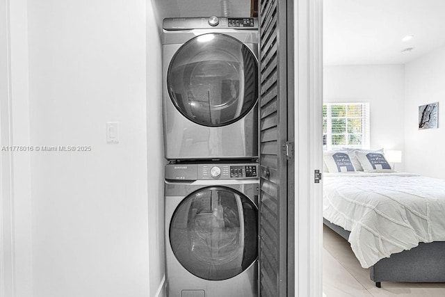 laundry area featuring stacked washer and clothes dryer and laundry area