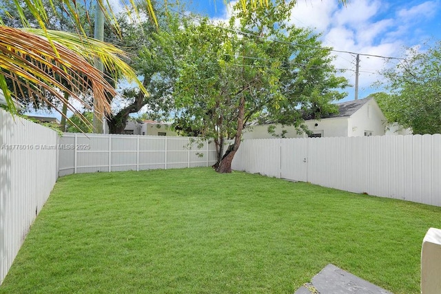 view of yard with a fenced backyard