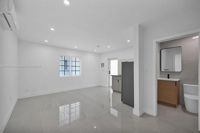 interior space with baseboards, a wall mounted AC, and recessed lighting