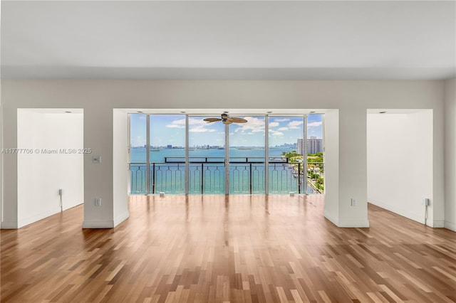11111 Biscayne Blvd Unit 16G, Miami, FL 33181 - unfurnished room with baseboards, a ceiling fan, plenty of natural light, and wood finished floors